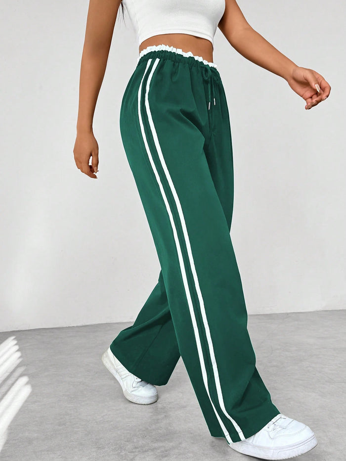 Donkerblauwe joggingbroek met witte strepen, elastische tailleband, sportief en trendy design, damesmode.