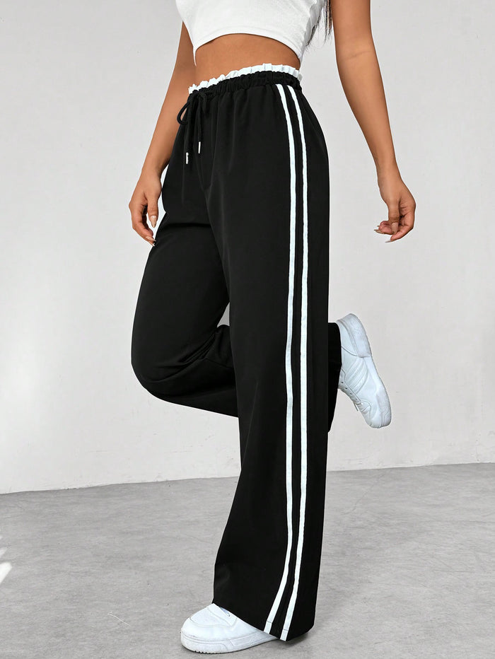 Donkerblauwe joggingbroek met witte strepen, elastische tailleband, sportief en trendy design, damesmode.