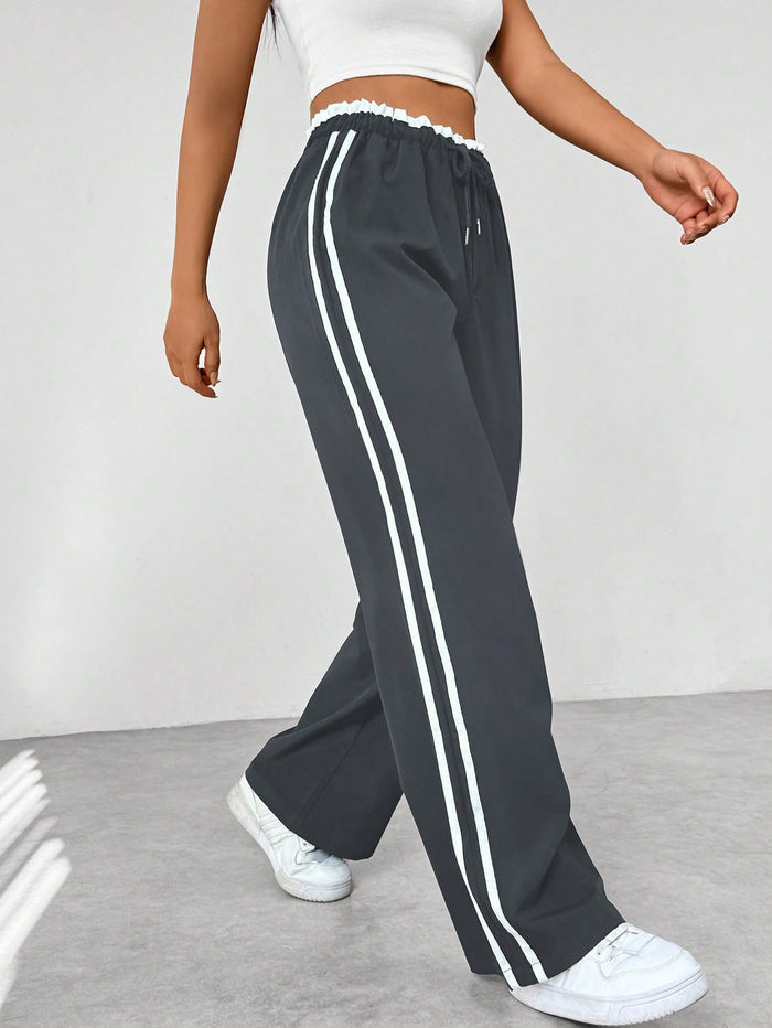 Donkerblauwe joggingbroek met witte strepen, elastische tailleband, sportief en trendy design, damesmode.