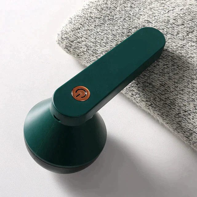 "Draadloze pluizenverwijderaar met groen-wit design, ergonomisch voor kleding en meubels onderhoud, compact en efficiënt."