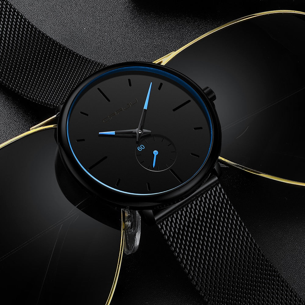 "Dun minimalistisch herenhorloge met elegante zwarte wijzerplaat, roestvrijstalen mesh-band en luxe uitstraling."