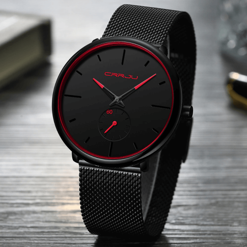"Dun minimalistisch herenhorloge met elegante zwarte wijzerplaat, roestvrijstalen mesh-band en luxe uitstraling."