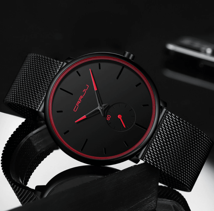 "Dun minimalistisch herenhorloge met elegante zwarte wijzerplaat, roestvrijstalen mesh-band en luxe uitstraling."