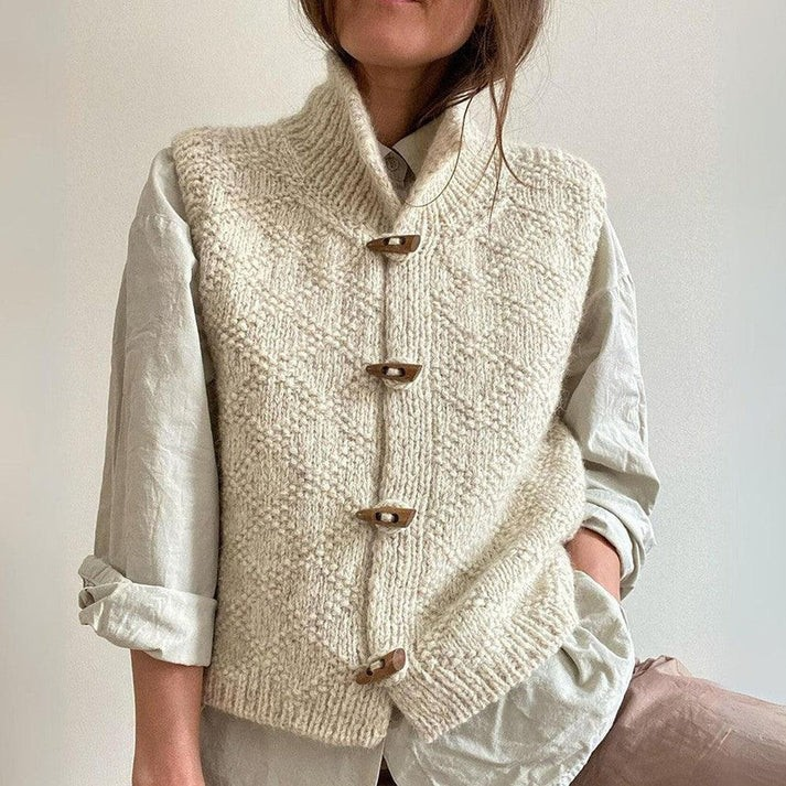 "Effen mouwloos damesvest, voorkant zichtbaar, elegante zwart-grijze kleur, ideaal voor diverse gelegenheden."