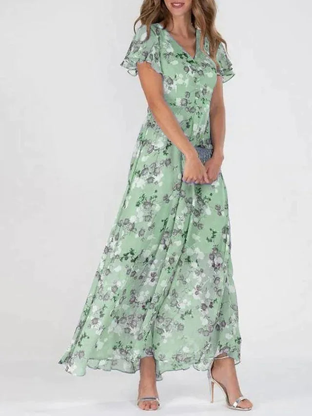 "Elegante chiffon jurk met bloemig patroon, subtiele V-hals en ruffles, ideaal voor zomerse gelegenheden."