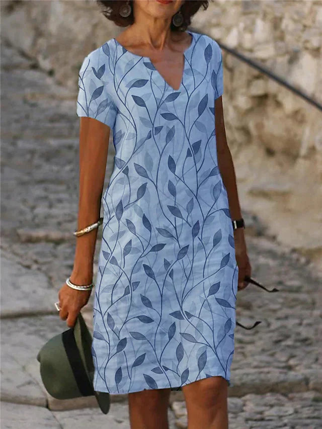 "Elegante groene en blauwe midi-jurk met V-hals en korte mouwen, ideaal voor zomerdagen. Vrouwelijke en stijlvolle look."