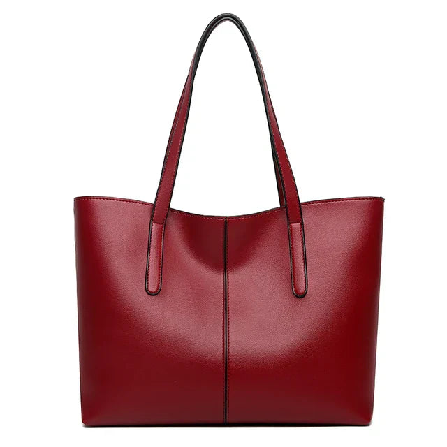 Elegante leren schoudertas in rood, met verstelbare riem en ruim interieur, perfect voor dagelijkse organisatie en stijl.