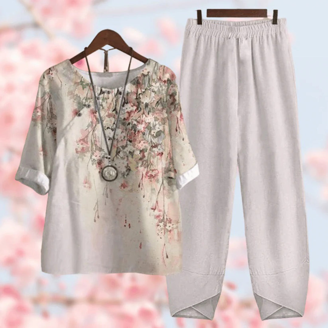 Elegante tweedelige set met vintage bloemenprint, losse top met korte mouwen en high-waist broek, stijlvol en comfortabel.
