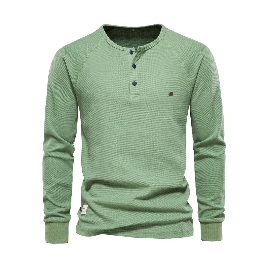 "Heren langemouwenshirt met ronde hals en knoopsluiting, beschikbaar in marineblauw, groen, lichtgrijs en wit."