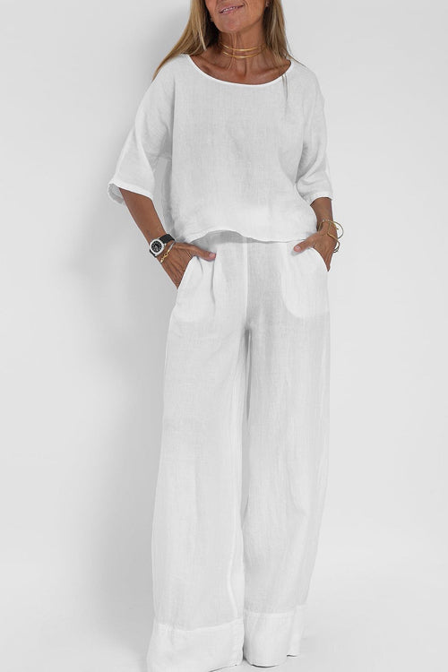 "Luchtige katoenen-linnen tweedelige set met wijde broek en cropped top, perfect voor zomerse elegantie en comfort."