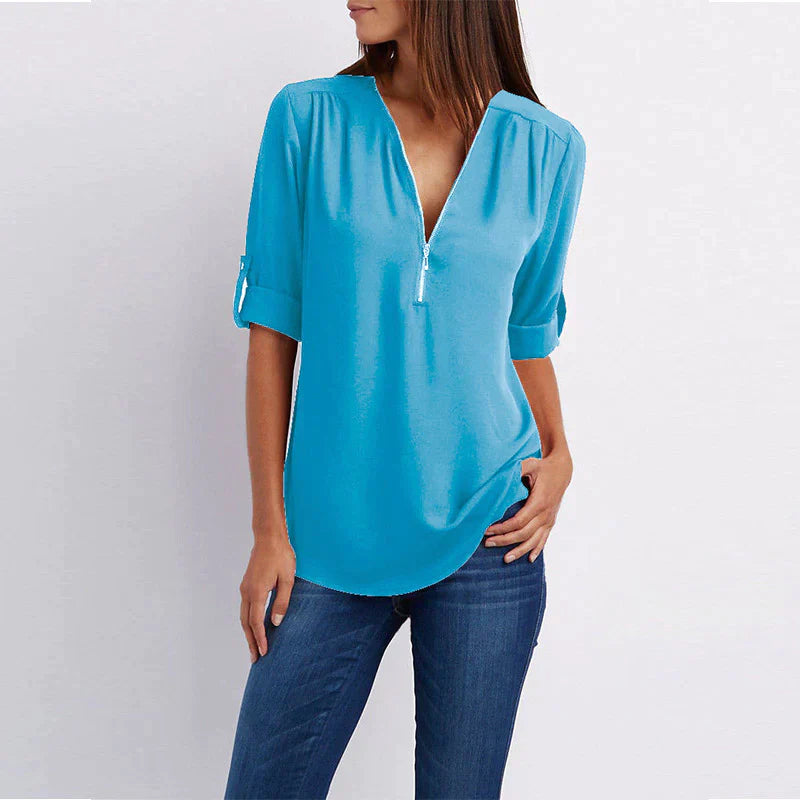 Stijlvolle Vera damesblouse met V-hals en rits in blauw, perfect voor diverse outfits en gelegenheden.