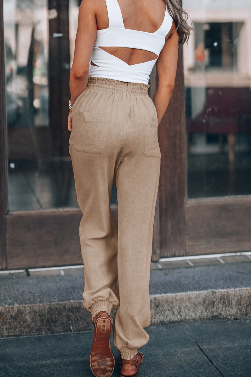"Trendy dames harembroek, elastische tailleband, luchtig materiaal, losvallend bij heupen, taps toelopend naar enkels."