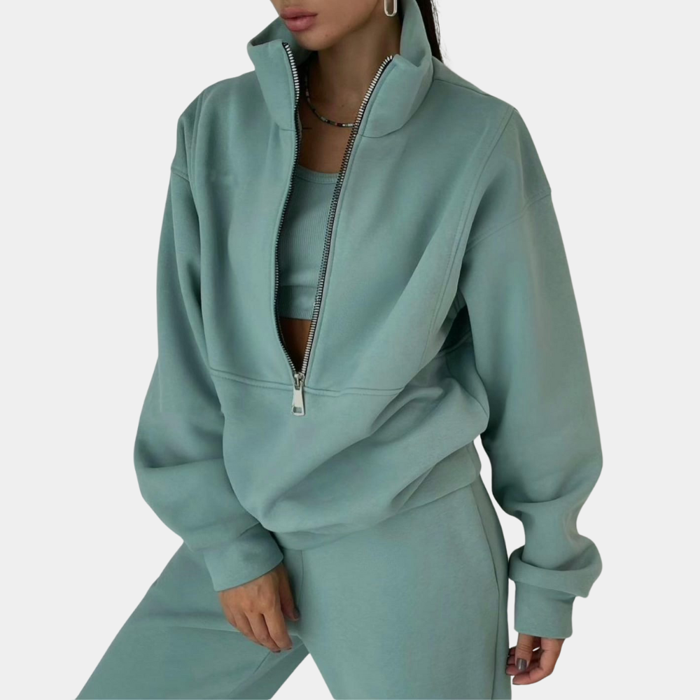 "Tweedelig dames joggingpak in groen, comfortabel met halve-rits vest en modieuze jogger, ideaal voor elke gelegenheid."