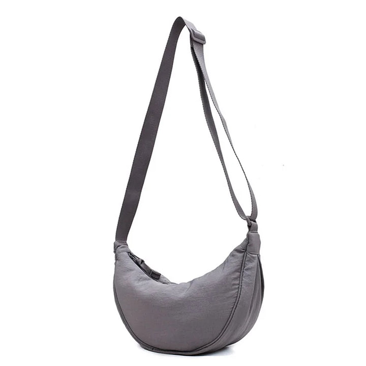 Trendy canvas dumpling schoudertas voor dames, combineert stijl met functionaliteit.