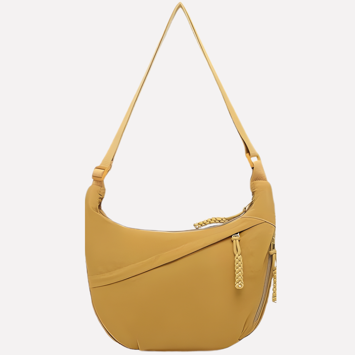 Dagelijkse halvemaan crossbodytas van nylon. Een ruime en praktische dames tas met verstelbare band.