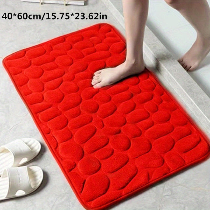 Dikke, absorberende polyester badmat; biedt warmte en antislip comfort.