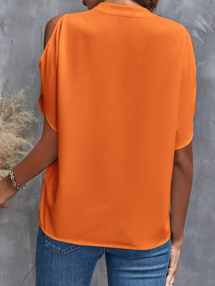 Comfortabel vintage oranje dames shirt met cut-out schouders, V-hals. Geschikt voor casual en Koningsdag.