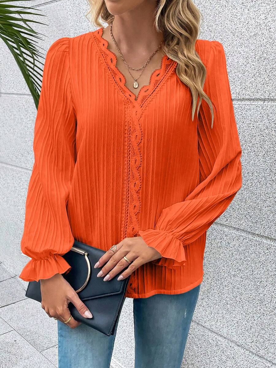 Stijlvol oranje dames top met lange kanten mouwen, perfect voor Koningsdag, lente of een chique gelegenheid.