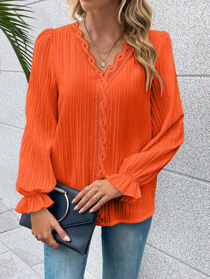 Stijlvol oranje dames top met lange kanten mouwen, perfect voor Koningsdag, lente of een chique gelegenheid.