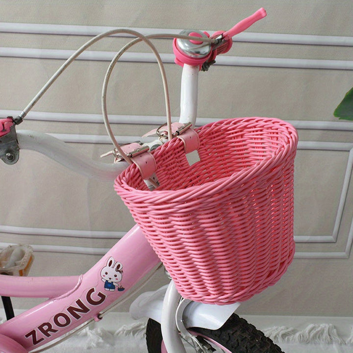 Roze handgeweven fietsmand van plastic riet voor kinderfiets, duurzaam accessoire.