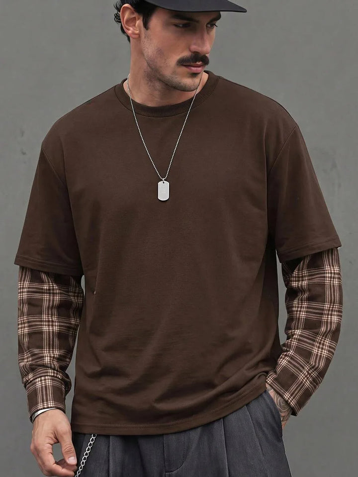 Stijlvol heren t-shirt met plaid patchwork mouwen. Lange mouw, comfortabel en trendy.