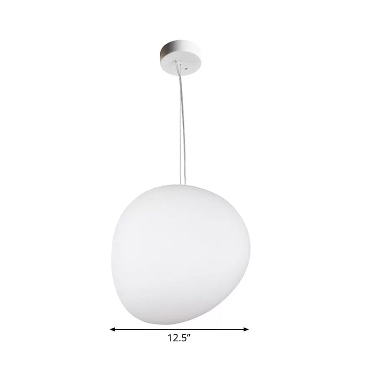 Elegante zwevende eetkamerlamp, kiezelvormig; creëert sfeervolle verlichting boven de eettafel.