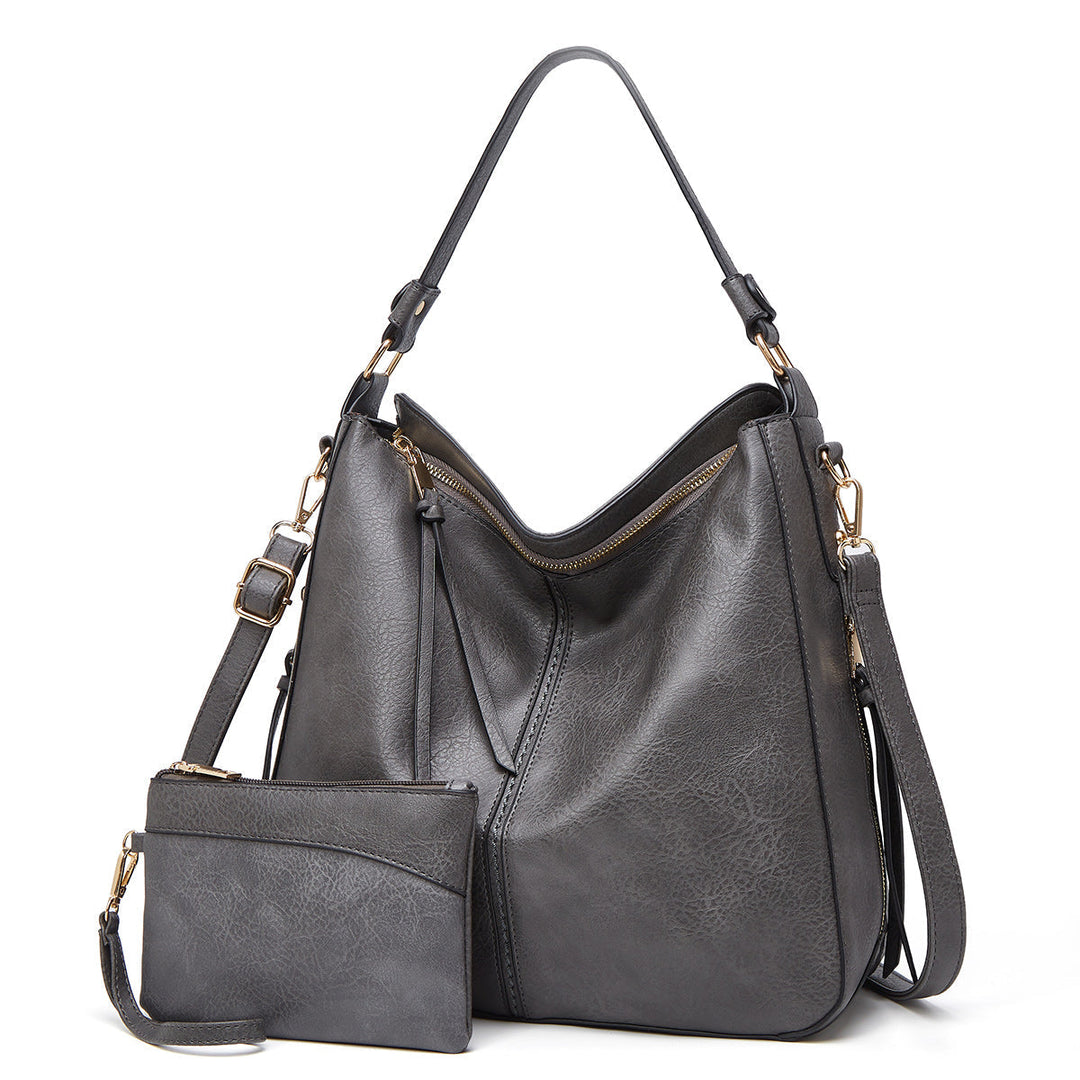 Chique leren handtas voor dames, perfect voor een elegante look, met subtiele gouden details.