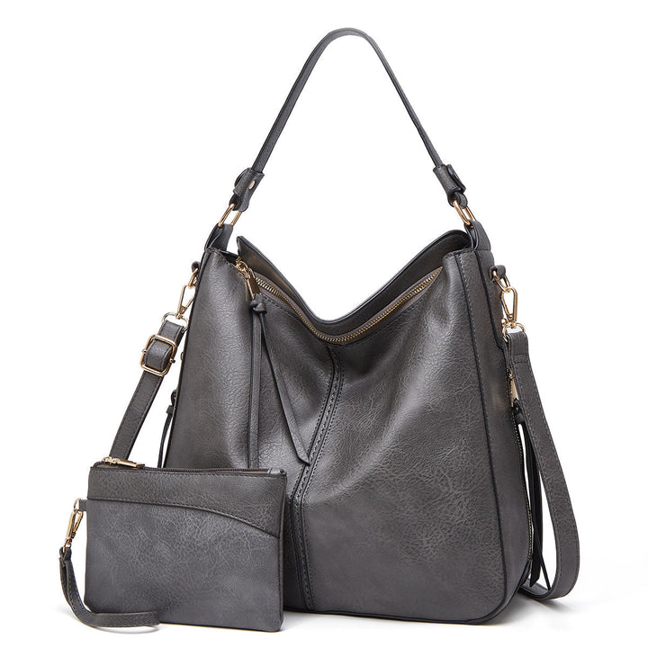 Chique leren handtas voor dames, perfect voor een elegante look, met subtiele gouden details.