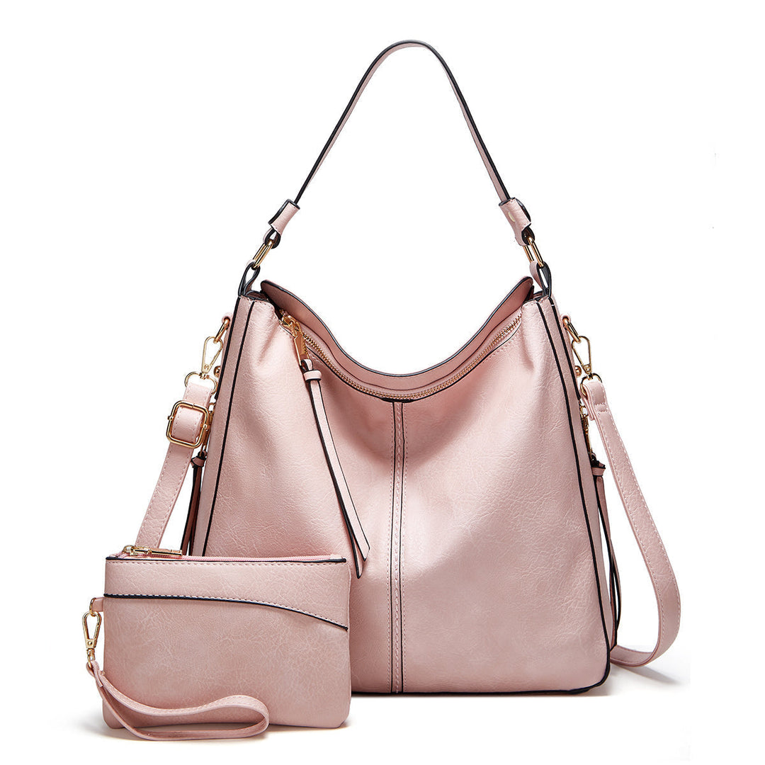 Veelzijdige leren crossbody tas voor dames, ideaal als handtas of schoudertas, met goudbeslag.