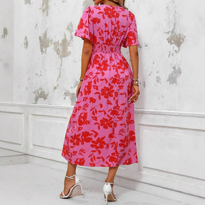 Elegante roze midi jurk voor dames, met een vrolijke bloemenprint en verleidelijk split detail.