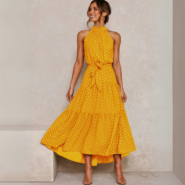 Dames midi-jurk met stippenprint en flatterende A-lijn pasvorm, perfect voor de zomer.