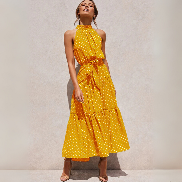 Elegante mouwloze dames midi-jurk met stippenprint, ideaal als feest- of vakantie jurk.