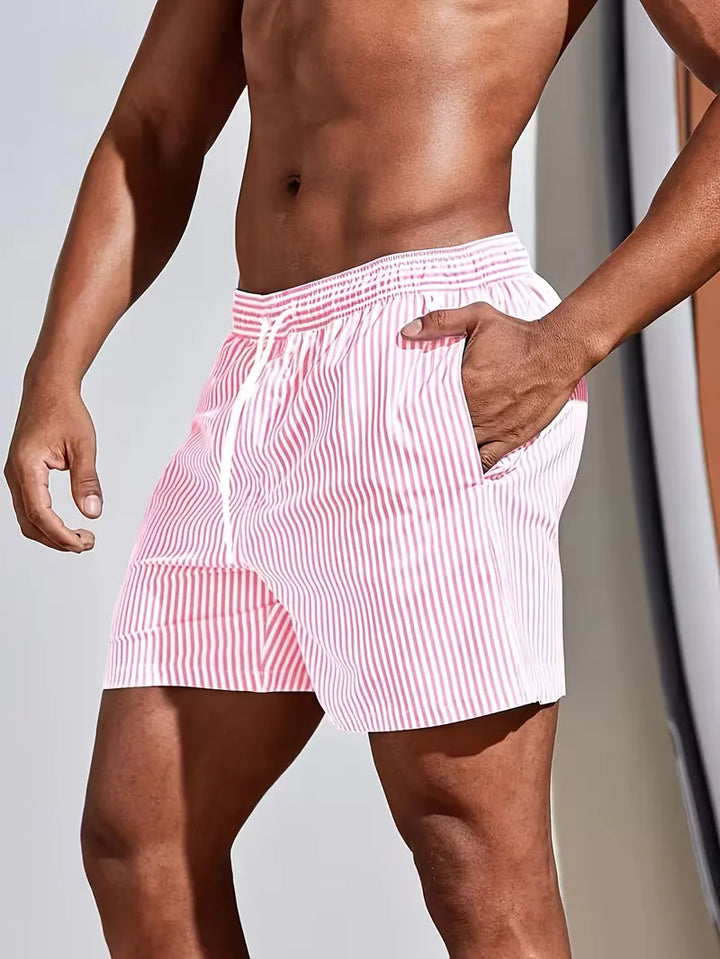Zomerse heren zwemshorts: comfortabel gestreept model in blauw en roze, ideaal voor strand en zwembad.