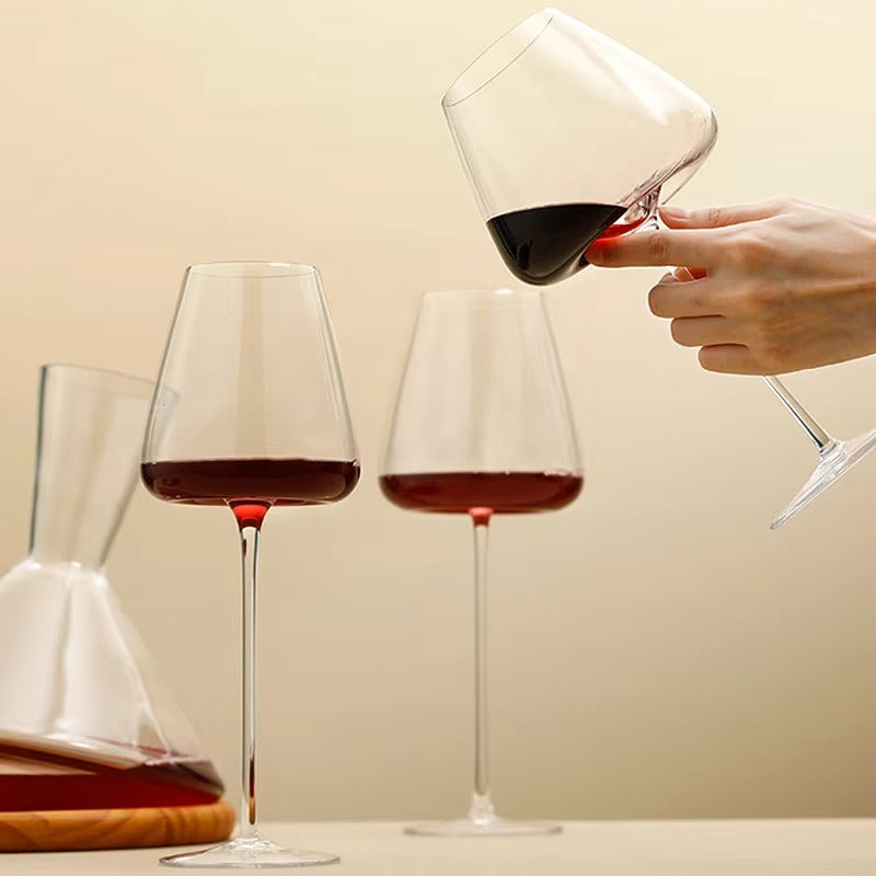 Hand die een elegant Cristallo wijnglas vasthoudt, met zicht op de glanzende kristallen steel.