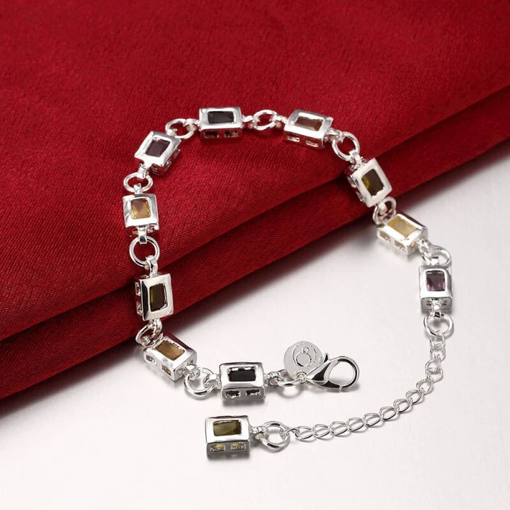 Damesarmband met heldere meerkleurige zirkonia stenen, subtiel glanzend en verstelbaar voor elke pols. Exclusief sieraad.