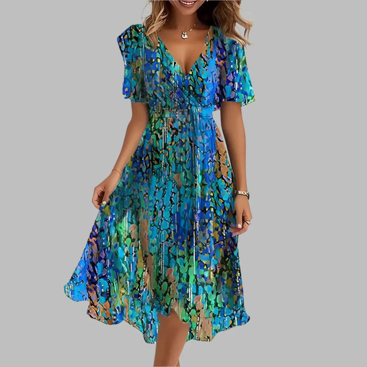 Dames stijlvolle geplooide midi-jurk met levendige bloemenprint, perfect voor zomerse dagen.