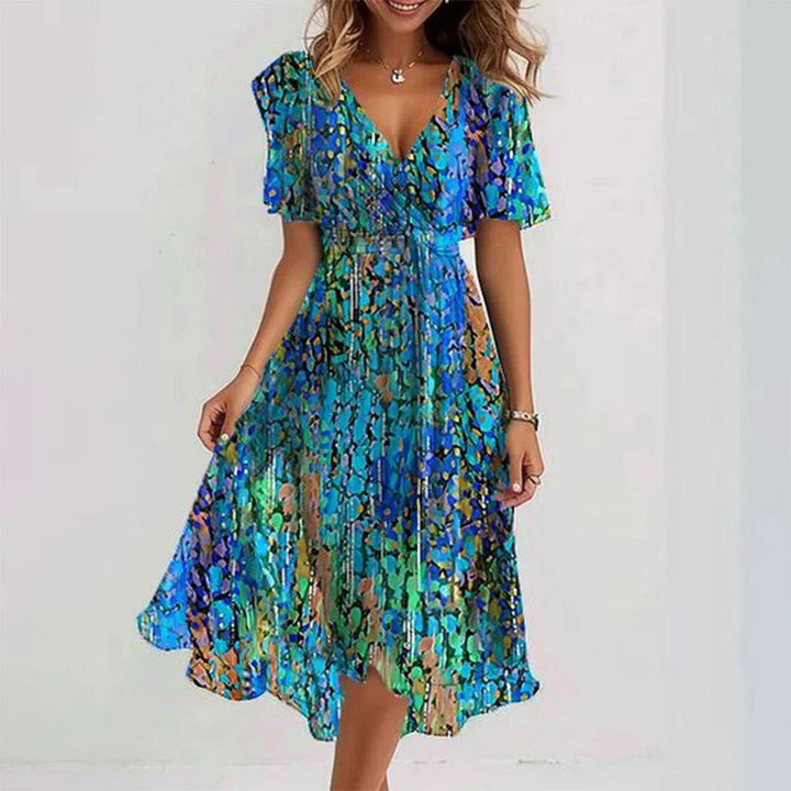 Elegante dames midi jurk met levendige bloemenprint, perfect voor zomerse dagen en lentefeesten.