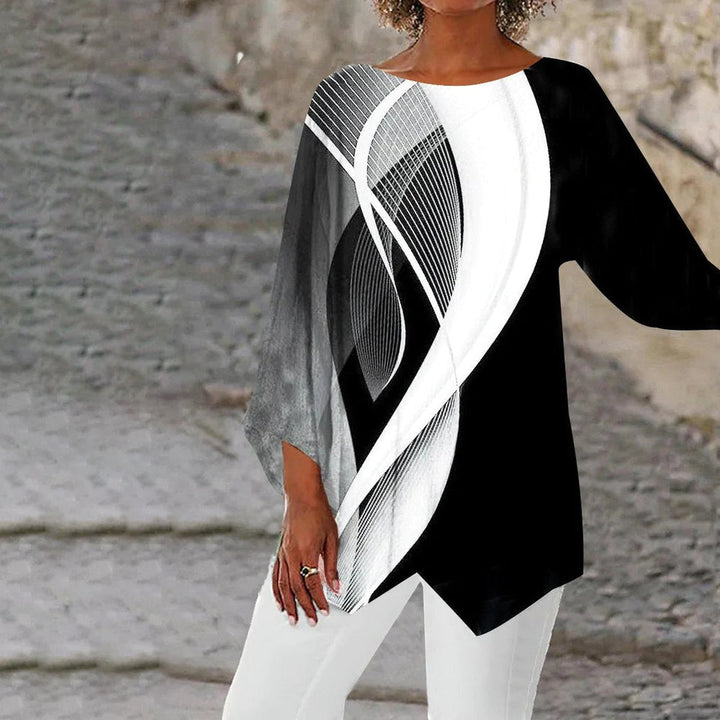 Dames tuniek met lange mouwen en trendy zwart-wit geometrisch patroon. Comfortabele, moderne mode voor een stijlvolle look.