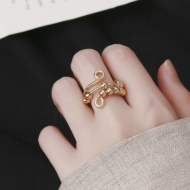 Gouden fidget ring met draaibare kralen voor stressverlichting, een unisex accessoire.