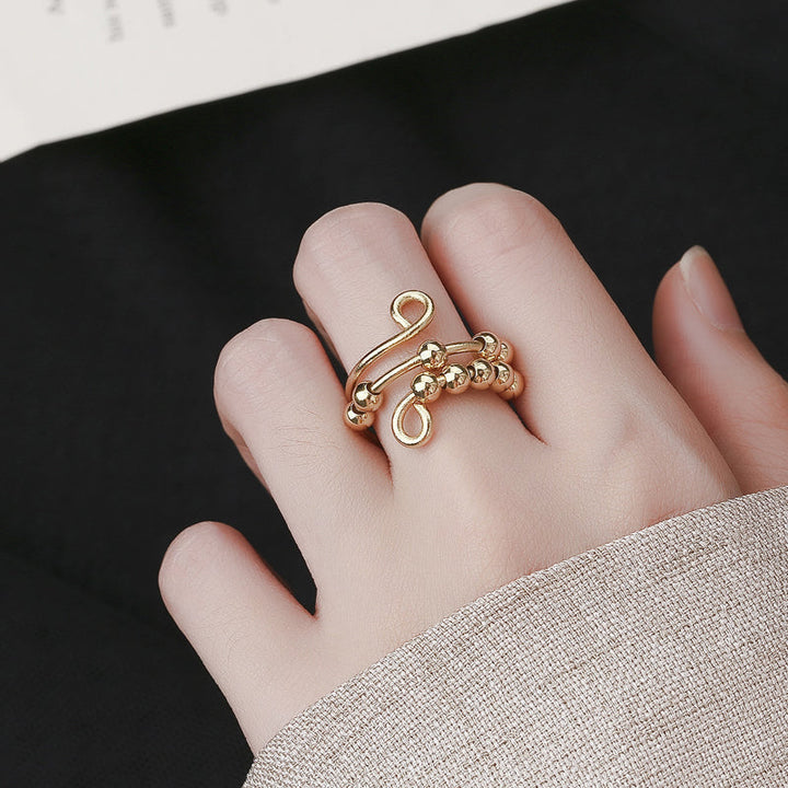 Gouden fidget ring met draaibare kralen voor stressverlichting, een unisex accessoire.