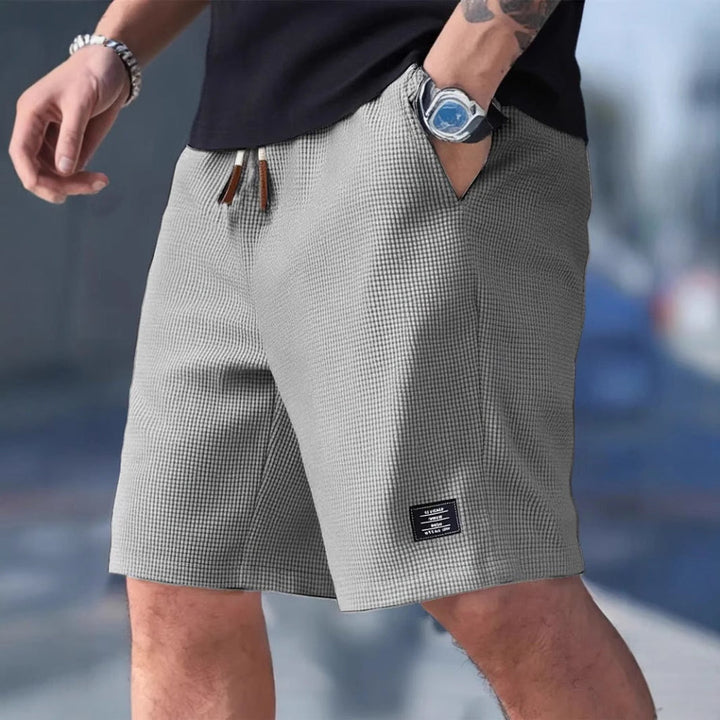 Zomerse heren sportshort met trekkoord voor optimale pasvorm, comfortabel en losvallend, met zakken.