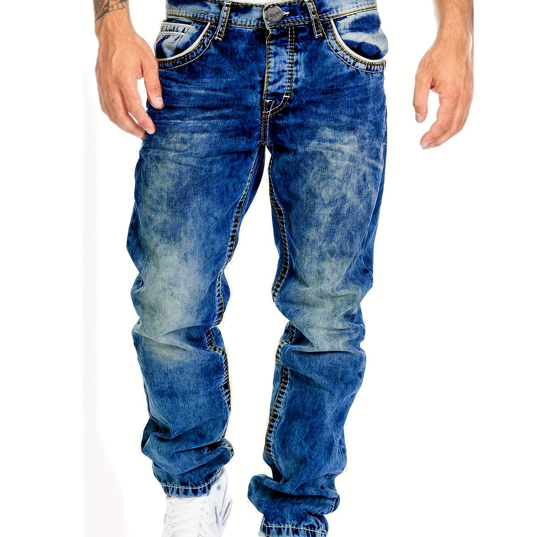 Man draagt stoere heren distressed punk jeans, slim fit. Combineert met streetwear outfit, casual mode.