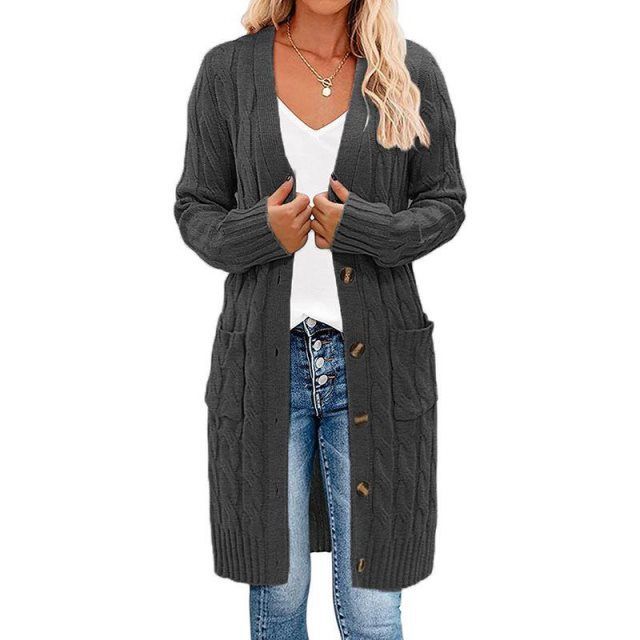 Elegant lang damesvest, gedraaid gebreid. Biedt warmte en stijl als essentieel stuk dameskleding voor herfst.