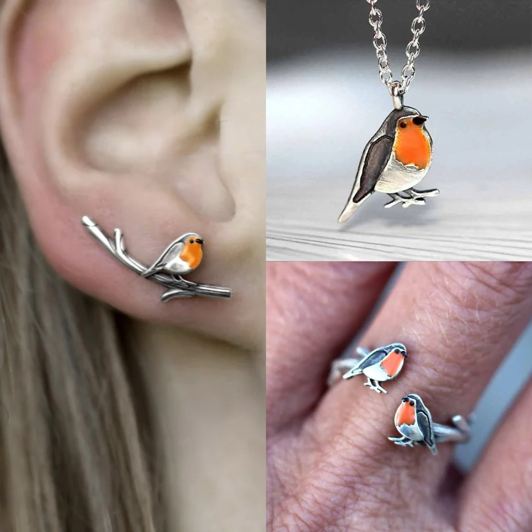Geluksvogel sieradenset op een zachte ondergrond, uitstralend hoop en de belofte van een nieuw begin. Dames sieraad.