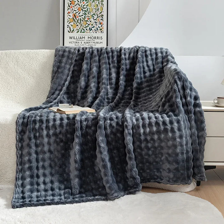 Netjes gevouwen extra zachte PlushBubble flanellen deken, perfect als warme plaid of woonaccessoire.
