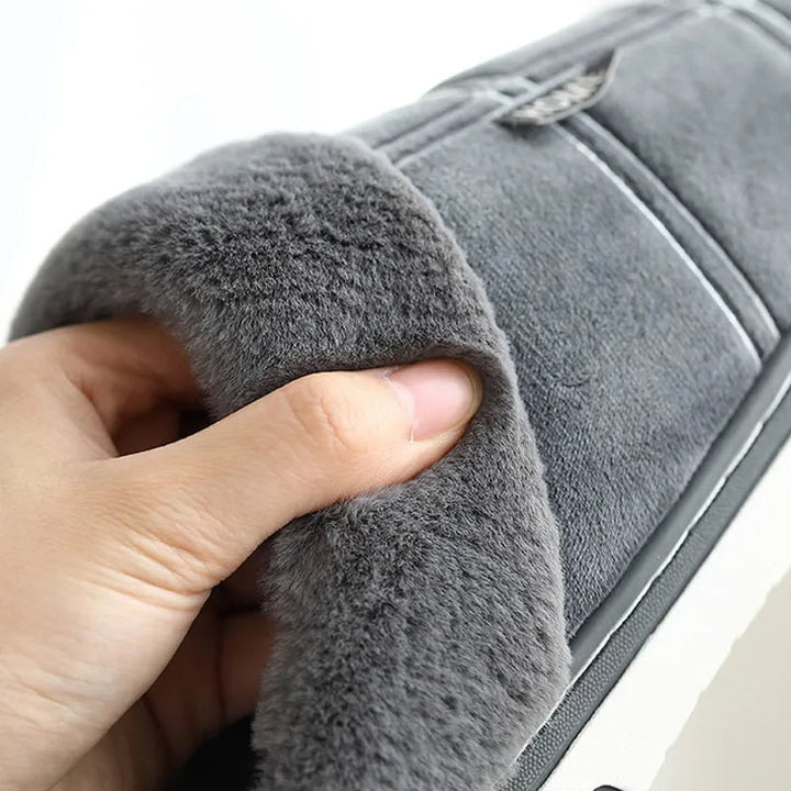 Dichtbij van het geruite patroon op warme, comfortabele herenpantoffels.