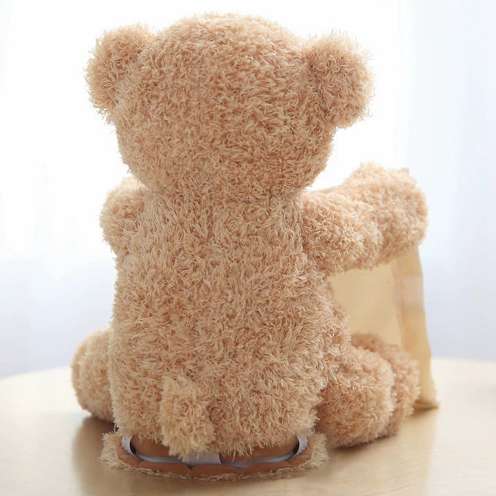 Bruine pluche knuffelbeer die peek-a-boo speelt. Sprekend en zingend zacht kinderspeelgoed. Geweldig voor 2 jaar.