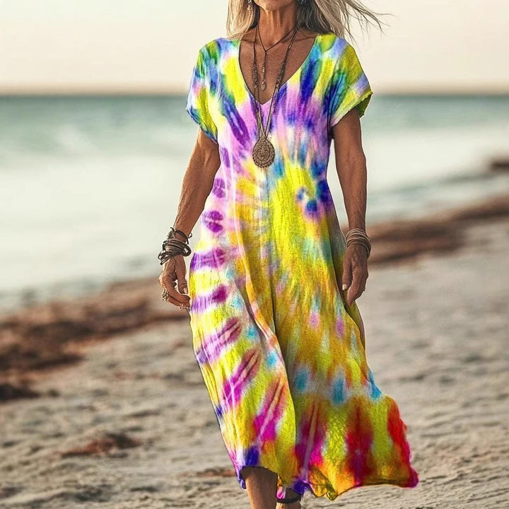 Kleurrijke maxi damesjurk met unieke vlinderprint, een elegante keuze voor elke zomerse gelegenheid of feestje.