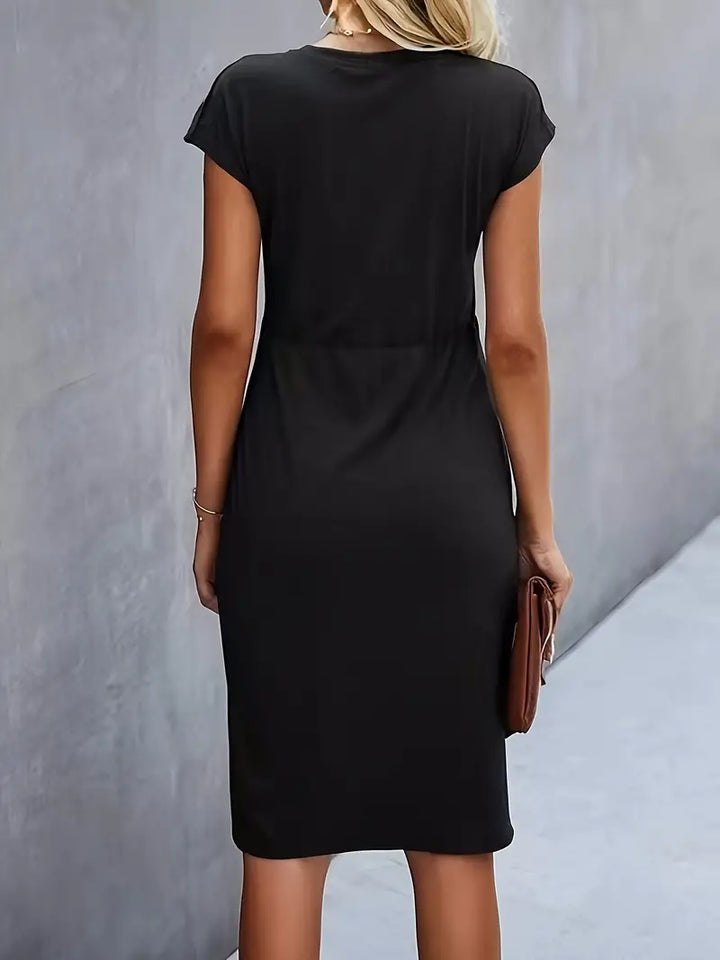 Model draagt een comfortabel stretch damesjurkje, zijaanzicht. Accentueert de elegante pasvorm.