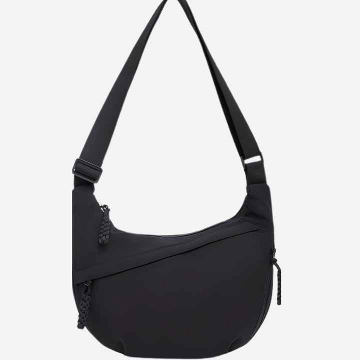 Modieuze halvemaan tas van nylon voor dames. Veelzijdige schoudertas met een comfortabele, verstelbare riem.
